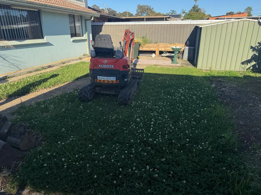 Before: Insight mini excavator on the backyard lawn at Chipping Norton