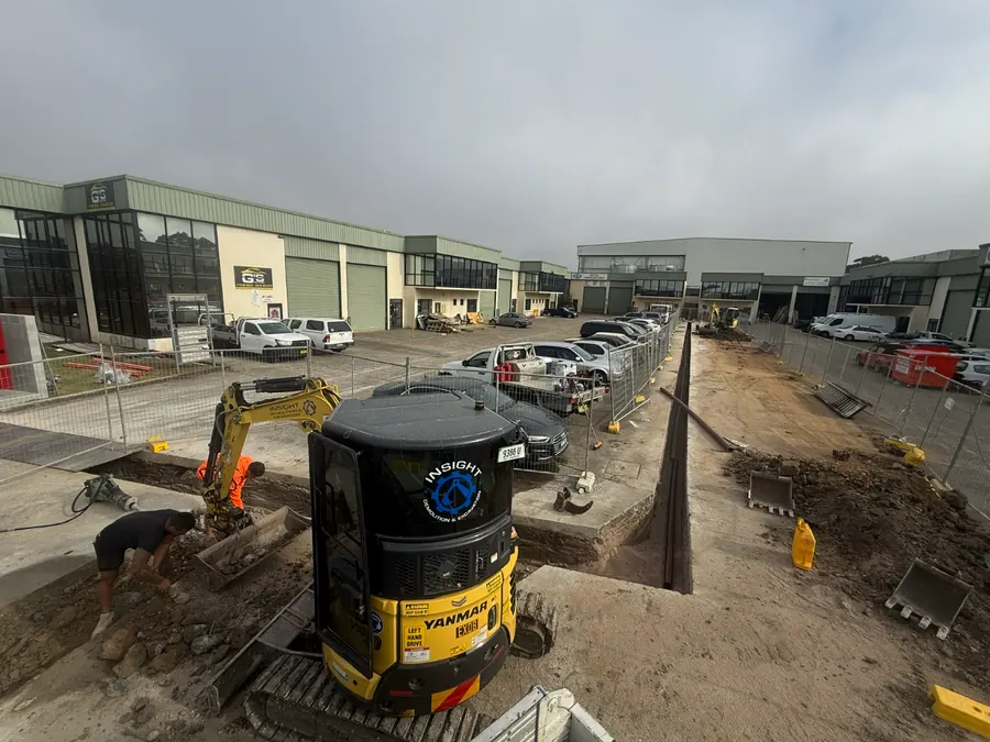 After: Insight mini excavator beside the trench, cut through the concrete and dug along the marked line for a 140m fire hydrant service